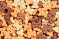 Close up of bone shaped dog treats in different colors and flavoures for rewarding and training small dogs and puppies. Macro food Royalty Free Stock Photo