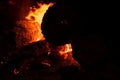Close up of bonfire with a sparks at night. Heat from burning logs and coals in the dark Royalty Free Stock Photo