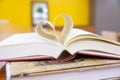 Close up book image in heart shape on the table. Royalty Free Stock Photo