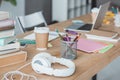 close up of books, headphones, coffee, copybooks and laptop