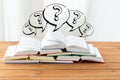 Close up of books on table and question marks