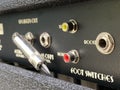 Close-up the boost input jack of a back control panel electric guitar amplifier with blurred another control panel black Royalty Free Stock Photo