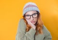 Close up bored young woman looking at camera, isolated on yellow background