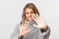 Close-up of bothered blond girl defending herself, grimacing from something disgusting or too bright, standing over Royalty Free Stock Photo