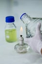 Close-up of bottle being sterilized with an alcohol burner before use in marine plankton culture in Scientific laboratory Royalty Free Stock Photo