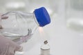 Close-up of bottle being sterilized with an alcohol burner before use in marine plankton culture in Scientific laboratory Royalty Free Stock Photo