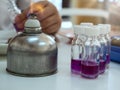 Close-up of bottle being sterilized with an alcohol burner before use in bacterial cultures. Medicine and microbiology concept