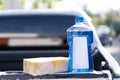 Close up bottle of car wash soap with yellow sponge for washing, selective focus Royalty Free Stock Photo