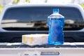 Close up bottle of car wash soap with yellow sponge for washing, selective focus Royalty Free Stock Photo