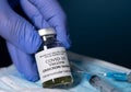 Close up of bottle of new Covid-19 vaccine for Omicron variant wtih gloved hand