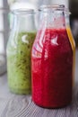 Close up bottles of fruit smoothies. Kiwi. Strawberry. Royalty Free Stock Photo