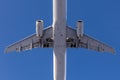Close-up bottom view of big passenger airplane. Blue clear sky on background Royalty Free Stock Photo