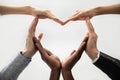 Concept of diverse business people join hands forming heart. Royalty Free Stock Photo