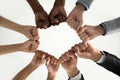 Close up diverse employees team holding fists in circle Royalty Free Stock Photo