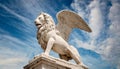 Statue of the Winged Lion of Saint Mark Against a Blue Sky with Clouds - Generative Ai Royalty Free Stock Photo