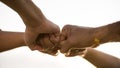 Close up bottom view of people giving fist bump showing unity and teamwork. Friendship happiness leisure partnership team concept Royalty Free Stock Photo