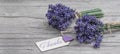 Close up of bouguet of violet purple lavendula lavender flowers herbs with wooden pendant with the word:
