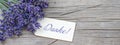 Close up of bouguet of violet purple lavendula lavender flowers herbs with wooden pendant with the word: