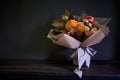 Close-up bouquet in a glass vase decorated in vintage style on a dark background, selective focus