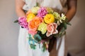 Close-up of bouquet in hands of florist in a dress