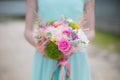 Close-up of bouquet in hands of a girl in mint dress Royalty Free Stock Photo