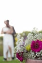 Close up of bouquet with newly couple dancing in background