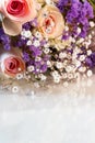 Close up of bouquet of pink roses mixed with small purple and white flowers Royalty Free Stock Photo