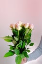 Close-up of bouquet of white, pink roses in hands of young man, brought flowers on date with girlfriend, gives to mom, concept of