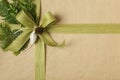 Beautiful Christmas gift wrapped in recycled wrapping paper with natural botanical decorations.