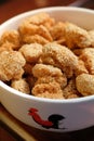 A close up of a bowl of Chinese sesame cookies.