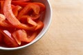 Bowl of freshly cut paprika or bell pepper on a wooden background Royalty Free Stock Photo