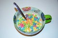 Close up of a bowl full of fruit flavored loops of sugar ready to eat breakfast cereal with a spoon sticking out Royalty Free Stock Photo