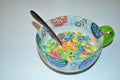 Close up of a bowl full of fruit flavored loops of sugar ready to eat breakfast cereal with a spoon sticking out Royalty Free Stock Photo