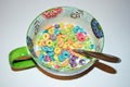 Close up of a bowl full of fruit flavored loops of sugar ready to eat breakfast cereal with a spoon sticking out Royalty Free Stock Photo