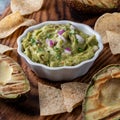 Close up of a bowl of homemade guacamole served with tortilla chips. Royalty Free Stock Photo