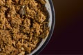 Close up of a bowl of red ancho chili pulled pork ready to use as a filling