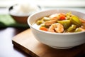 close-up of a bowl of seafood gumbo with shrimp and okra