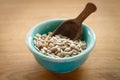 Close-up of a bowl of shelled sunflower seeds on a wooden background. Front view Royalty Free Stock Photo