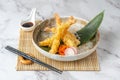 Close-up of a bowl of tempura shrimp with soy sauce and chopsticks next to it Royalty Free Stock Photo