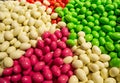 Close up of bowls filled with a large selection of different colored soft candies. Green, White, Red and pink candies