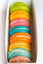 Close up of a box full of colorful macaroons.