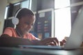 Close up of boy listening music while using laptop Royalty Free Stock Photo