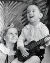 Close-up of a boy playing a guitar with his sister Royalty Free Stock Photo