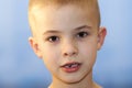 Close-up of boy smiling with missing front milk tooth over light Royalty Free Stock Photo