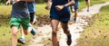 Close up of boys running on a dirt trail in a park with leaves on the ground Royalty Free Stock Photo