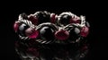 a close up of a bracelet with red and black beads