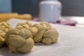 Close up of braided dough with rolling pin and flour jar in the background Royalty Free Stock Photo