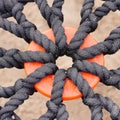 Close-up of braided rope mesh with orange ring in the middle