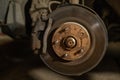 Close-up of a brake disc and pad on a car. Repairing and changing brakes on a car in a garage. A man repairs the brakes Royalty Free Stock Photo