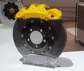 The close up of brake system with yellow caliper cover